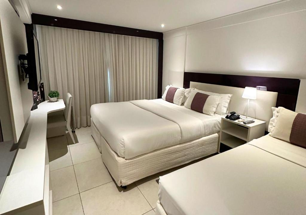 Cama ou camas em um quarto em Nord Luxxor Sapucaia