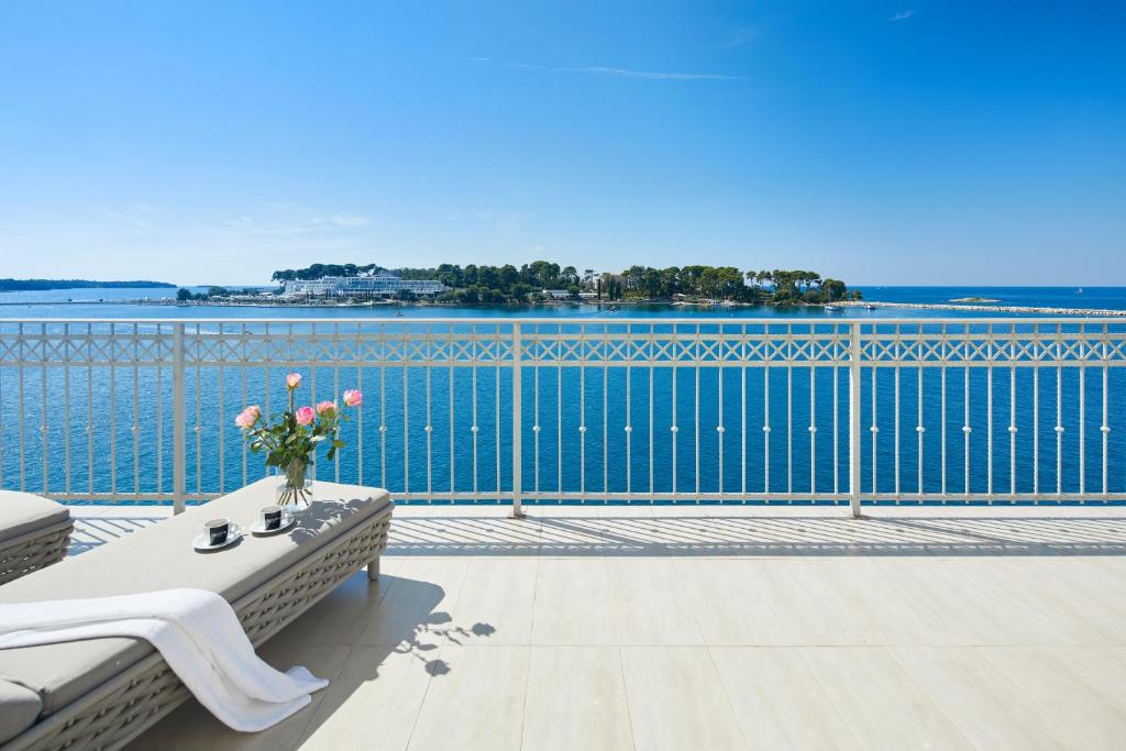 a balcony with a table and a view of the water at BO Hotel Palazzo in Poreč