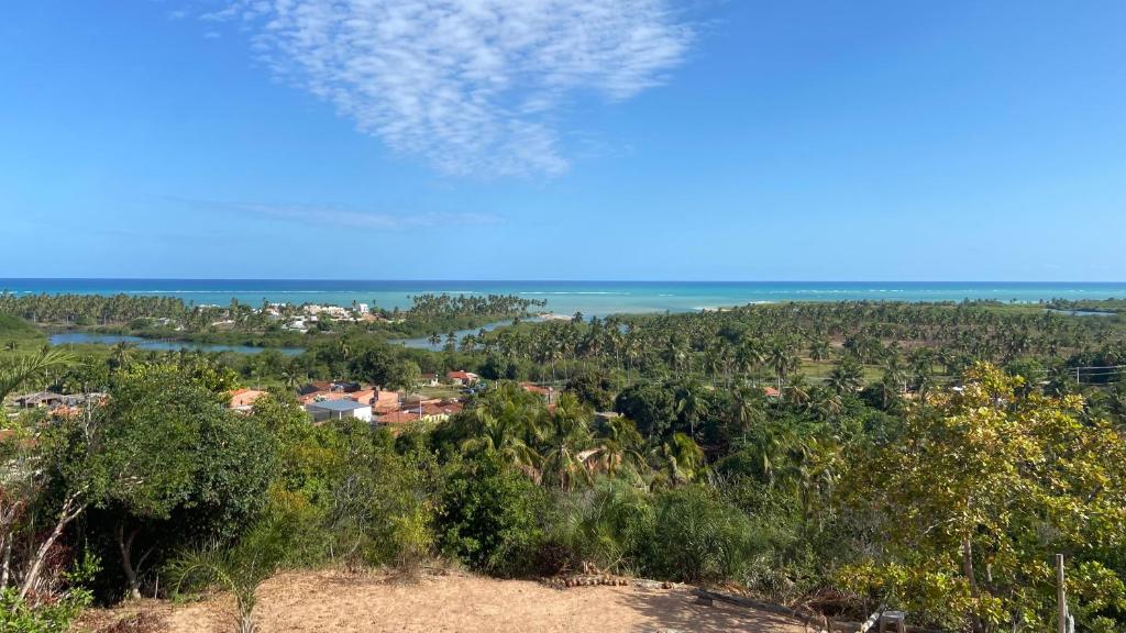 a view from the top of a hill with trees at Casa da Pri Suítes in Pôrto de Pedras