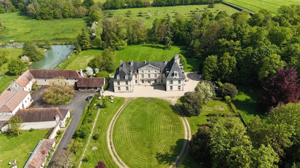 an aerial view of an estate with a large house at Château de Cesny-aux-Vignes in Cesny-aux-Vignes