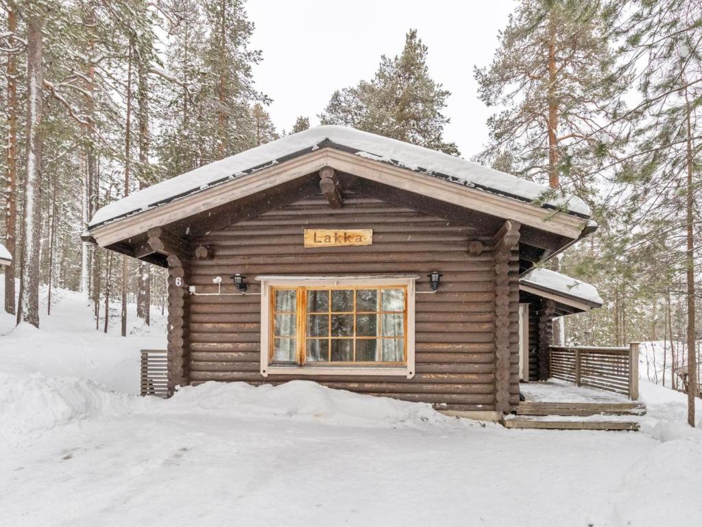 a log cabin with a sign on it in the snow at Holiday Home Lakka by Interhome in Salla