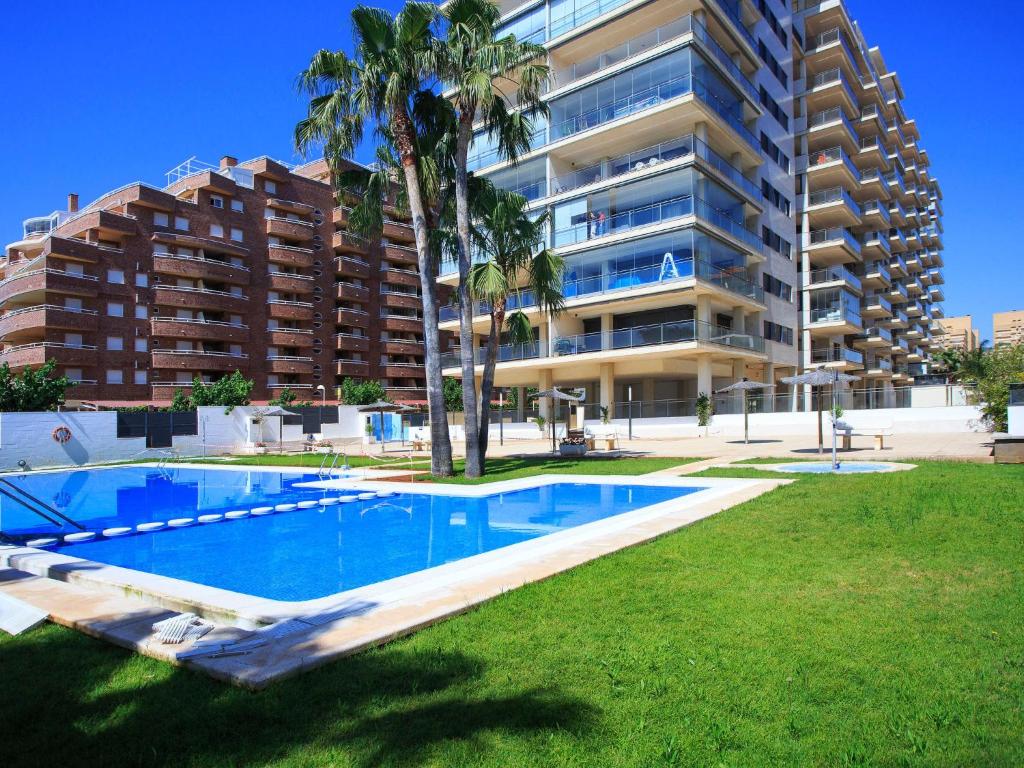 a swimming pool in front of a large apartment building at Apartment Las Terrazas- La Marina-1 by Interhome in Oropesa del Mar