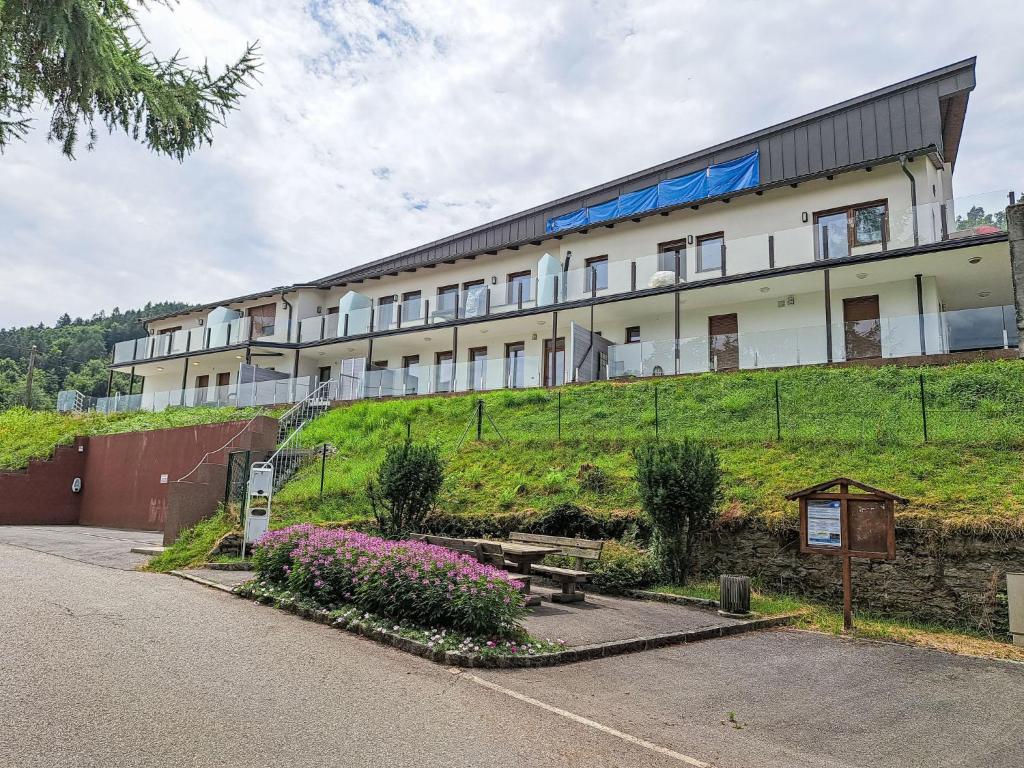a large building on top of a hill with flowers at Apartment Sunshine view 3 by Interhome in Sekirn