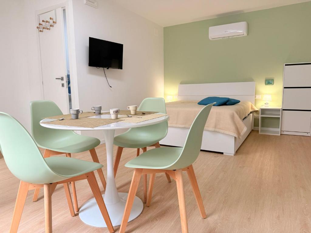 a room with a table and chairs and a bed at Ella vacanze in Grottammare