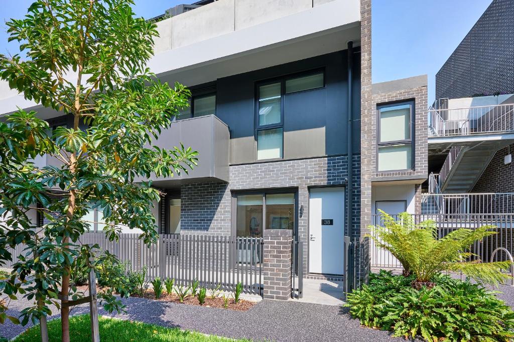 an apartment building with a black and white facade at Classy Spaces Keysborough - New 2 Storey Townhouse in Keysborough
