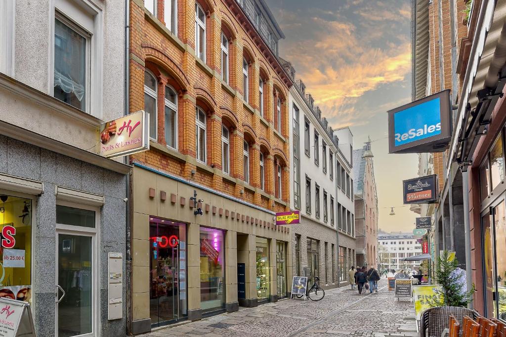 a city street with buildings and people walking down the street at ELLY NINE - stylish urban apartments in Wiesbaden