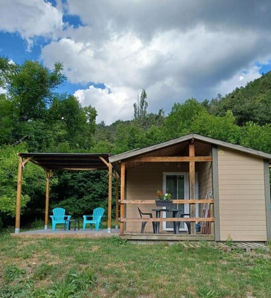 une petite cabine avec une table et deux chaises bleues dans l'établissement gîte à la ferme du Marquisat, à Crots