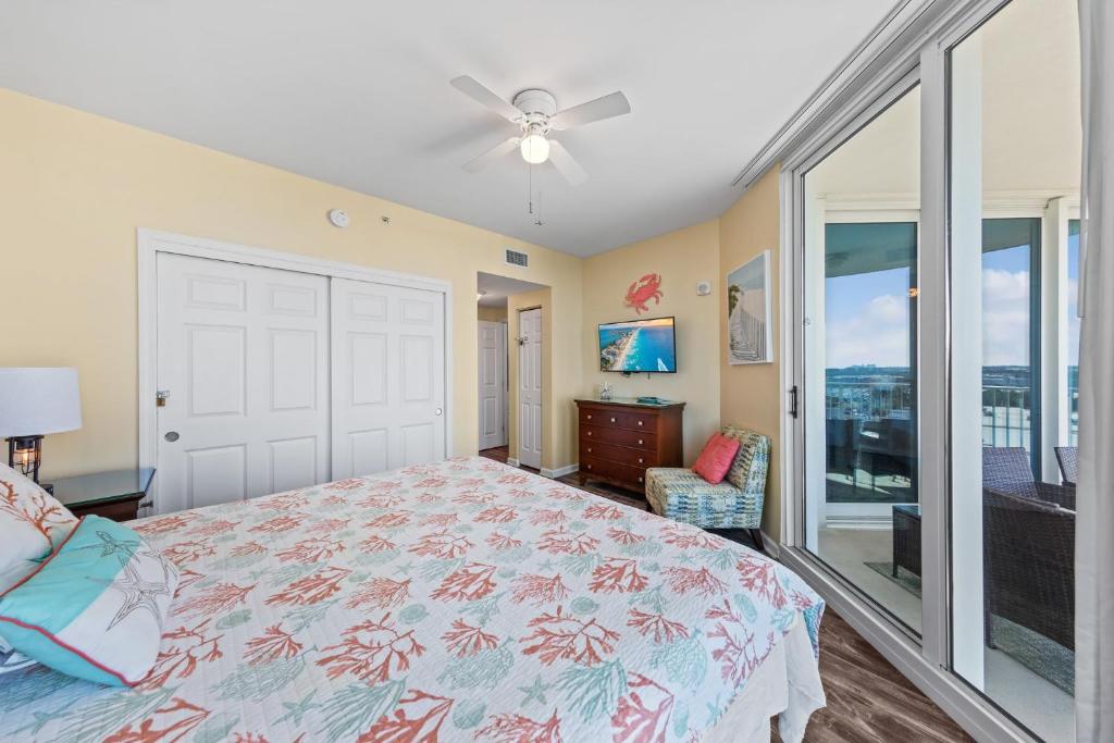 a bedroom with a bed and a ceiling fan at 5 Star Resort 11th Fl Stunning Sunrise 2BR 2BA King Suite,Pools ,Shuttle or Walk to Beach in Destin
