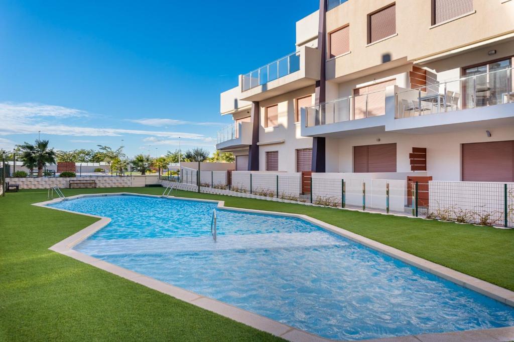 an image of a swimming pool in front of a building at Michael in Torre de la Horadada