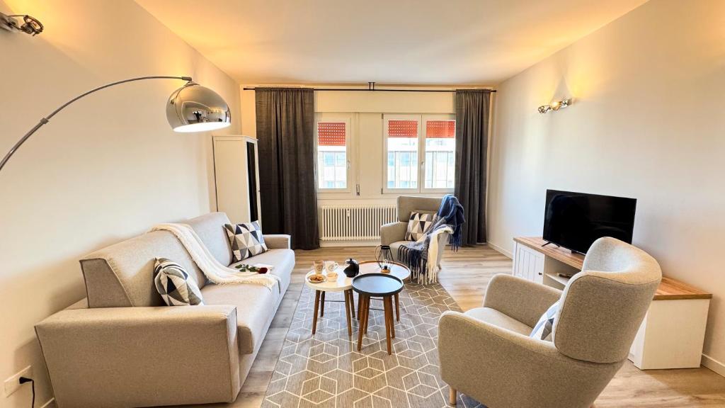 a living room with a couch and chairs and a tv at Venezia Dream Stay by Ca-Sa Check in Mestre