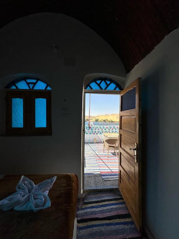a bedroom with a door open to a patio at Nubian King in Aswan