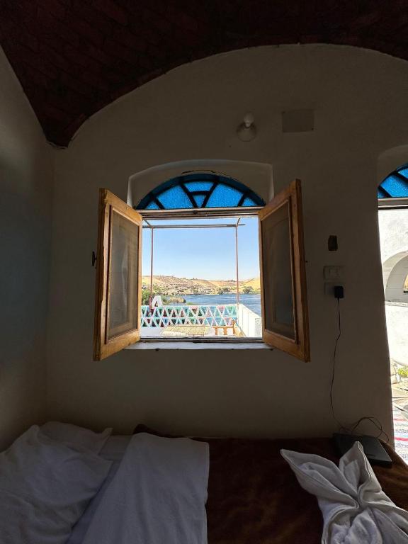 a bedroom with a window with a view of the ocean at Nubian King in Aswan