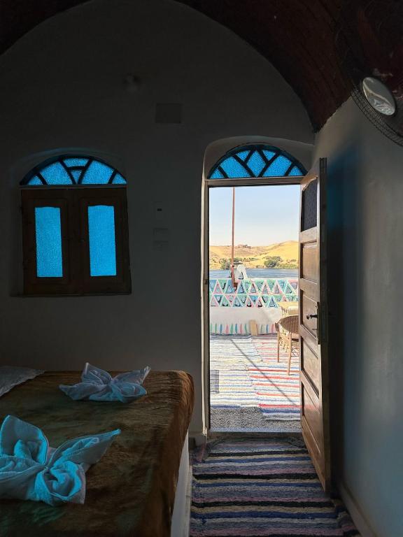 a bedroom with a door leading to a patio at Nubian King in Aswan