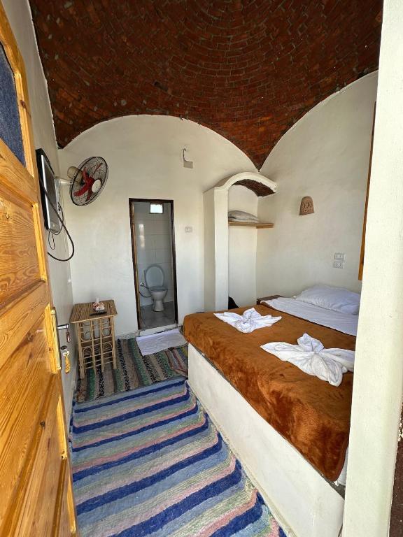 a bedroom with a bed with towels on it at Nubian King in Aswan