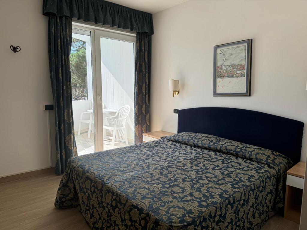 Postel nebo postele na pokoji v ubytování Hotel Carlton