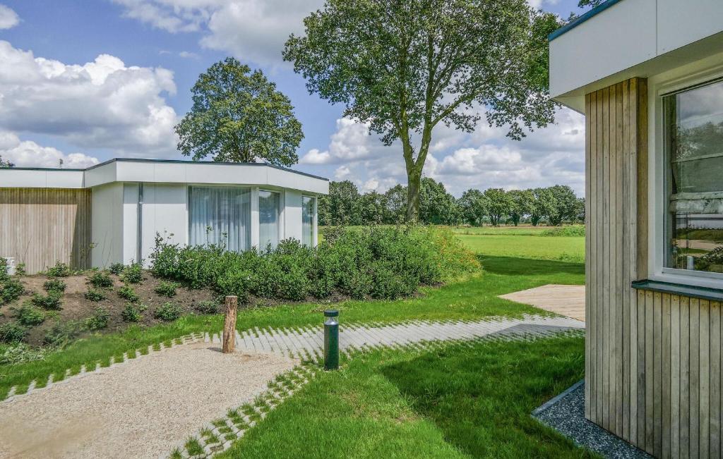 a house with a garden next to a building at Lovely Home In Afferden With Wifi in Afferden