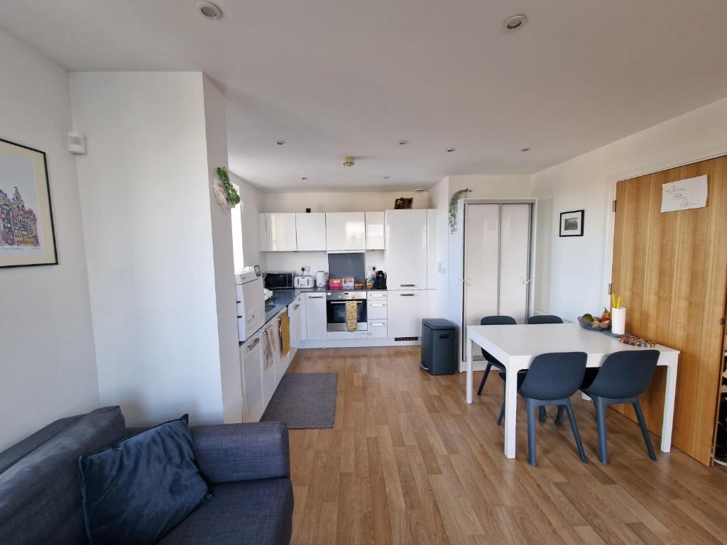 a living room with a couch and a table with chairs at Bright and Modern Forest Hill Flat - Flexible Stay in Forest Hill