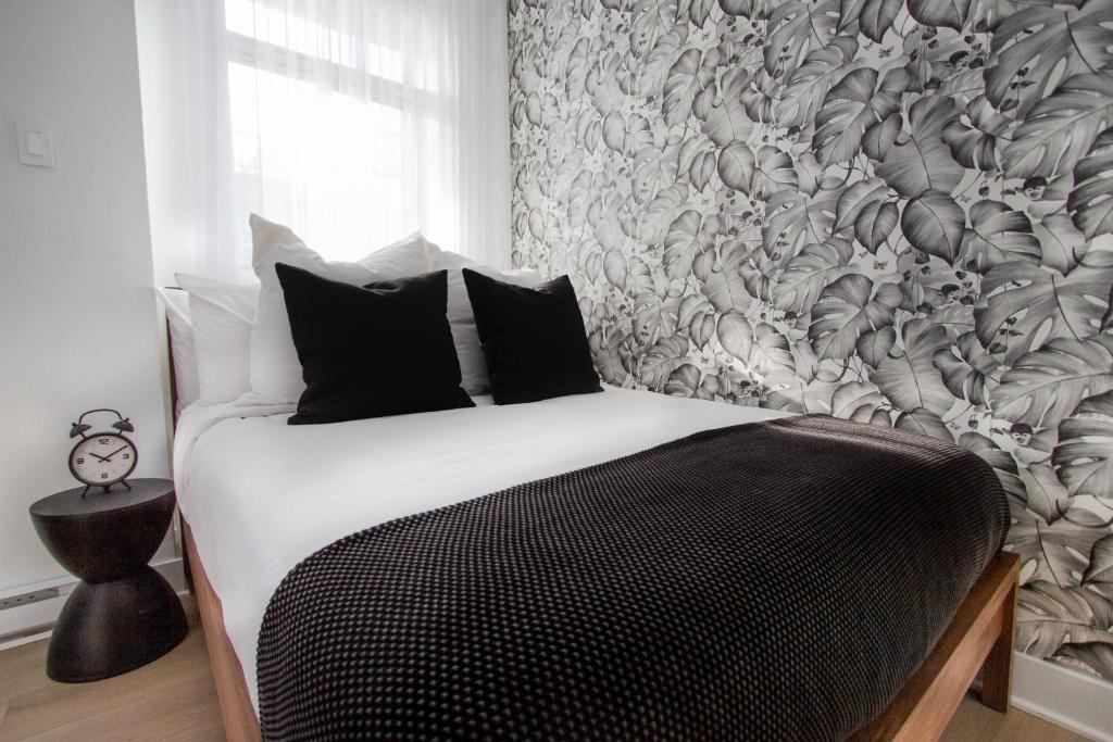 a bedroom with a bed with a floral wallpaper at Studio #9 - Self Check-In - Plateau - St-Denis in Montreal