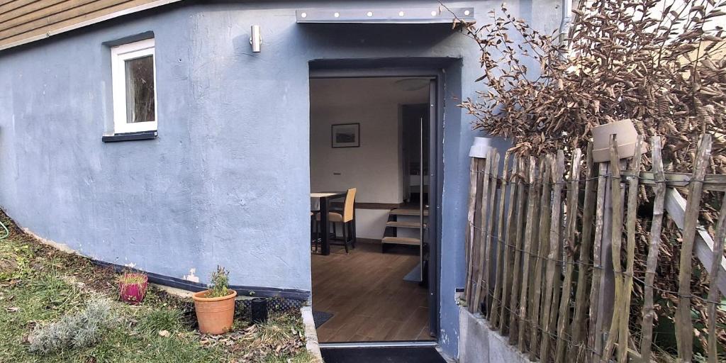 a door to a house with a fence at Wohnen am Weinberg in Rheinbreitbach