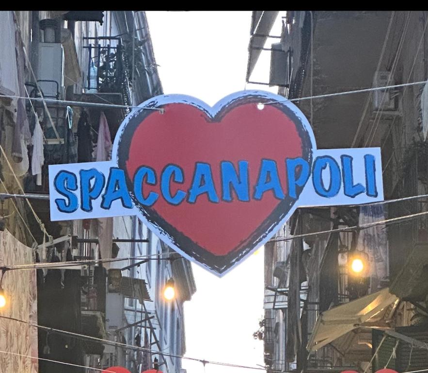 a sign for a restaurant on a building with a heart at la casa di patta a spaccanapoli in Naples