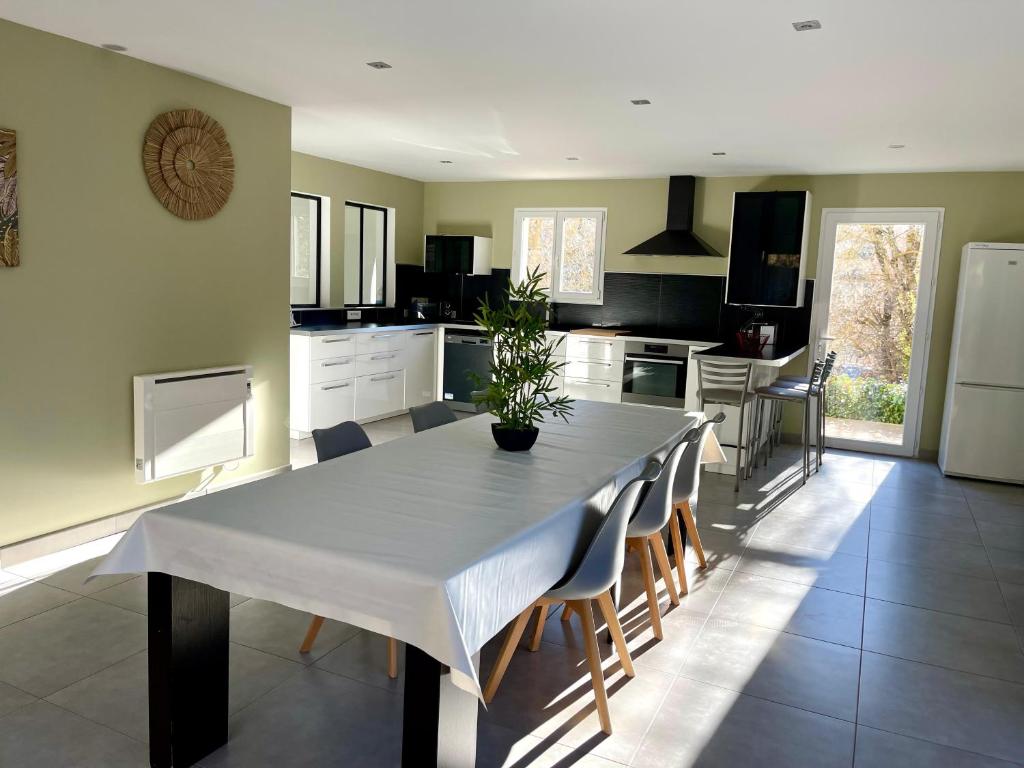 cocina con mesa blanca y sillas en Villa du Vallon, en Allemagne-en-Provence