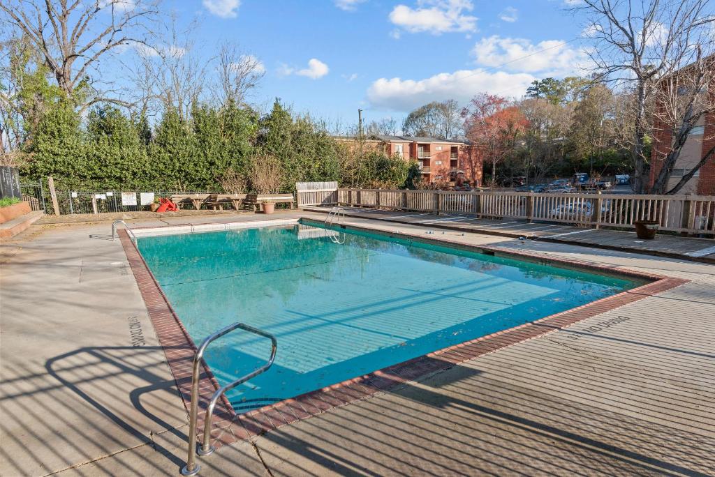a swimming pool in a yard with a blue poolvisor at Classic City Getaway at Stadium Village in Athens