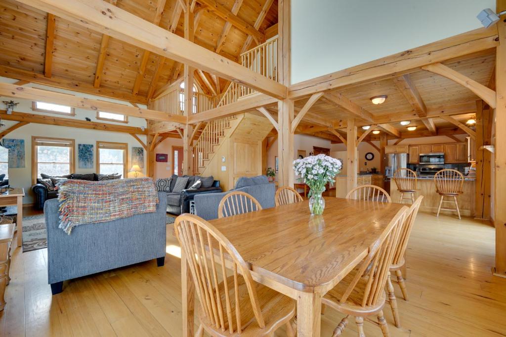 a dining room and living room with a wooden table at Secluded Vermont Retreat Outdoor Pool and Deck in Stratton