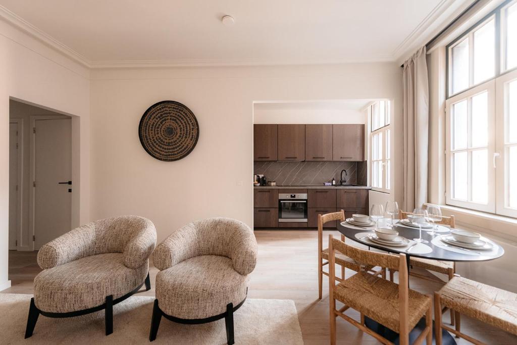a living room with a dining room table and chairs at Cathedral View luxurious Apartment in Antwerp