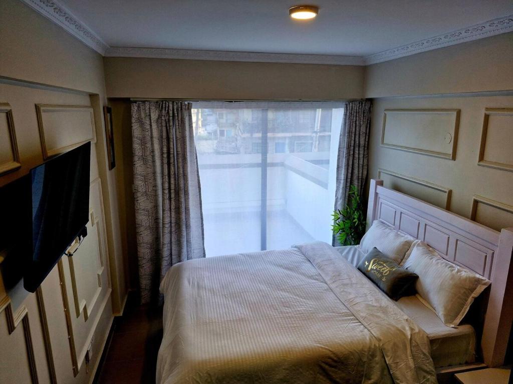 Ένα ή περισσότερα κρεβάτια σε δωμάτιο στο Homely Spot Nairobi West