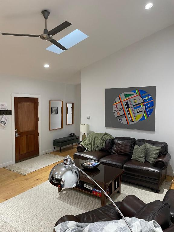 a living room with a couch and a ceiling fan at Urban Peak Escape in Lenox
