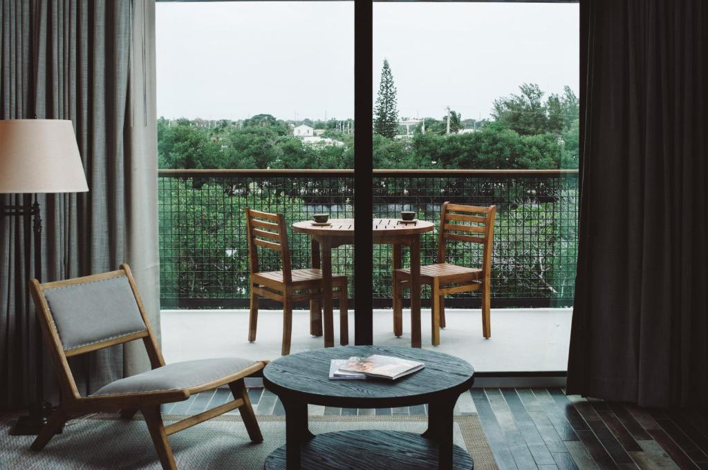 a room with a table and chairs and a large window at The Perry Hotel & Marina Key West in Key West