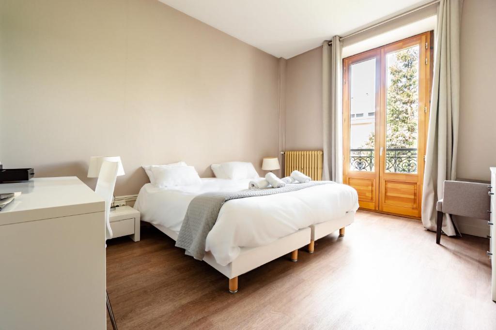 Posteľ alebo postele v izbe v ubytovaní Hôtel Gallia