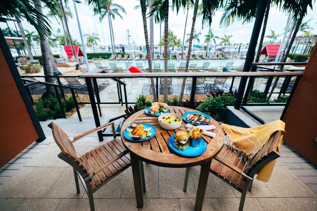 a table with plates of food on top of a balcony at The Perry Hotel & Marina Key West in Key West
