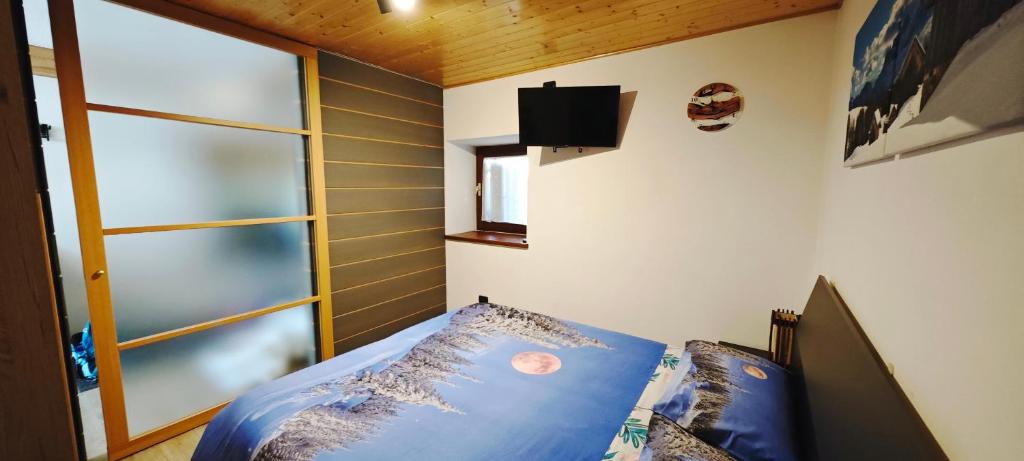 Posteľ alebo postele v izbe v ubytovaní Bilocale Nel Cuore Della Val Di Fiemme