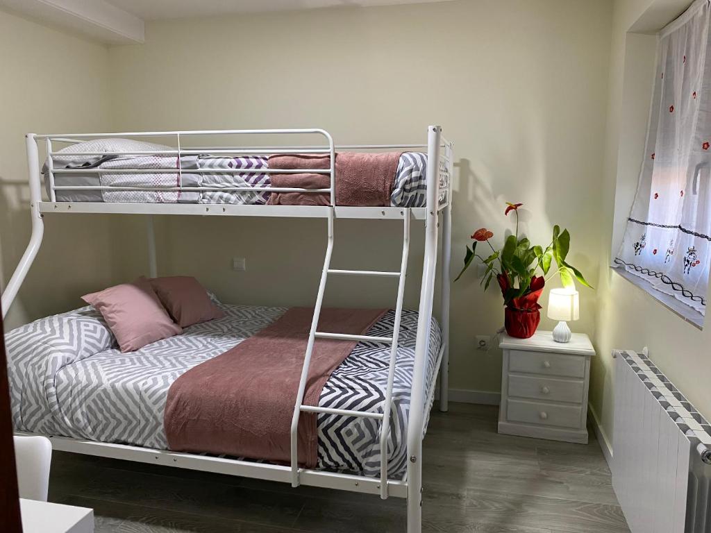 a bedroom with two bunk beds in a room at Casa los Patos en Santillana Del Mar in Santillana del Mar