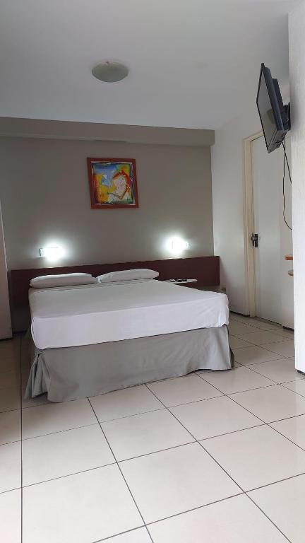 a bedroom with a large bed in a room at REDE APARTHOTEL Praia Mansa in Fortaleza