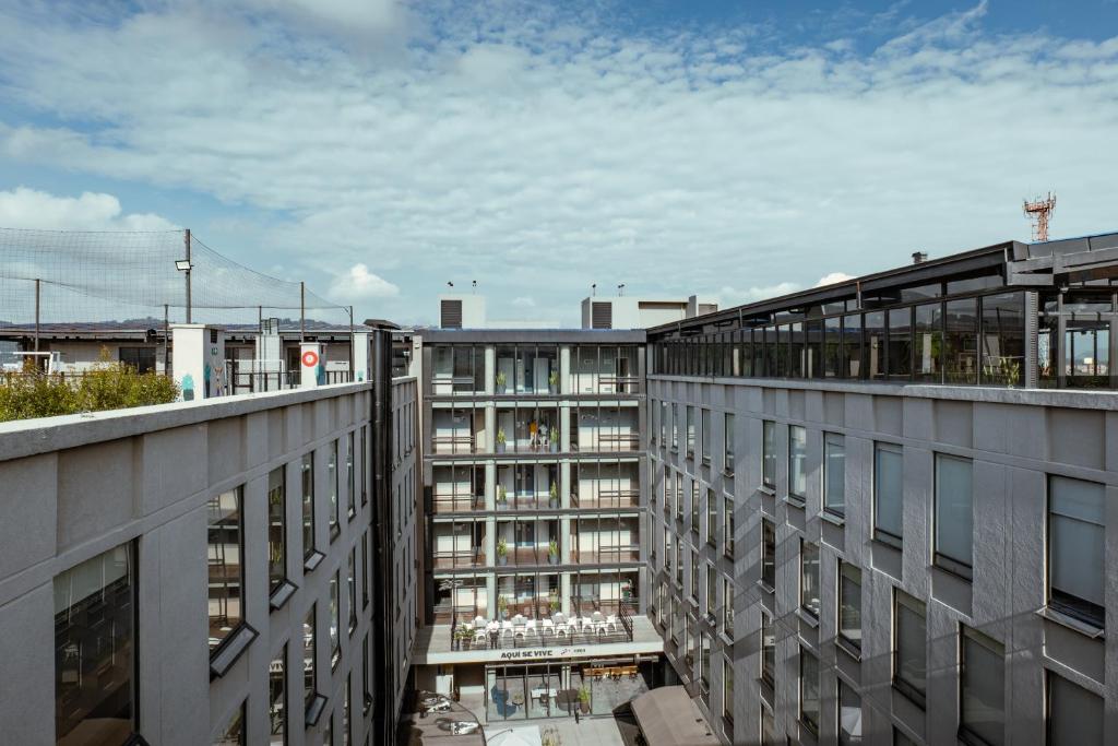 an apartment building with a view of a city at UMA Suites Chia in Chía