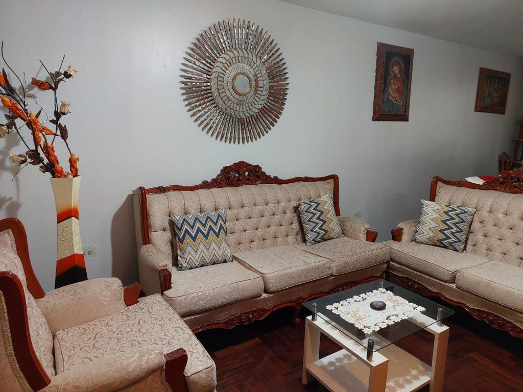 a living room with a couch and a table at Mandalas Cusco in Cusco