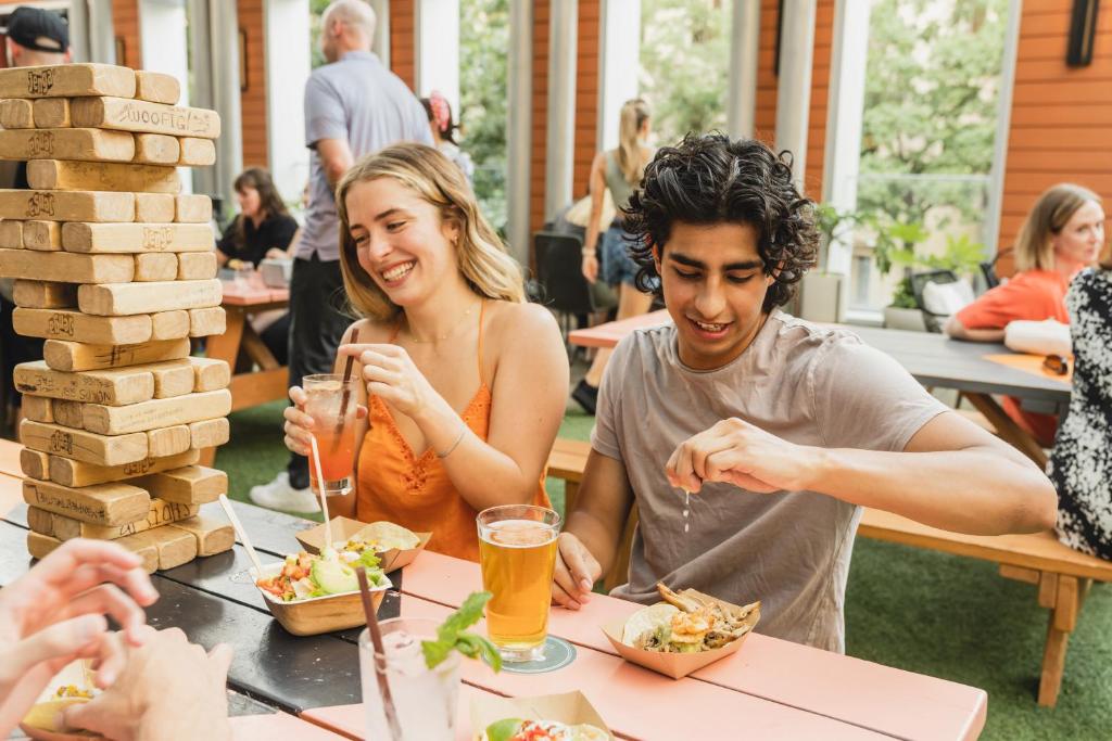 a group of people sitting at a table eating food at Aloft Austin Downtown in Austin