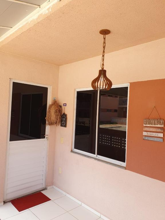 a room with a door and a chandelier at Ap Morada Nova in Petrolina
