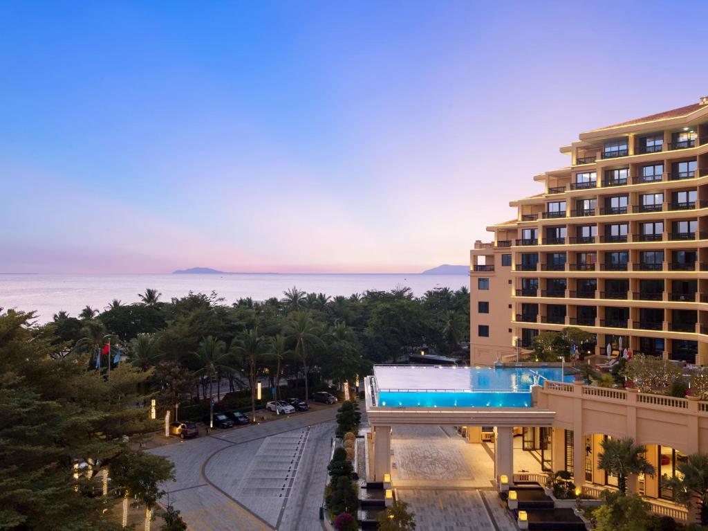 a view of a building with a swimming pool at Sanya Golden Phoenix Seaview Hotel in Sanya