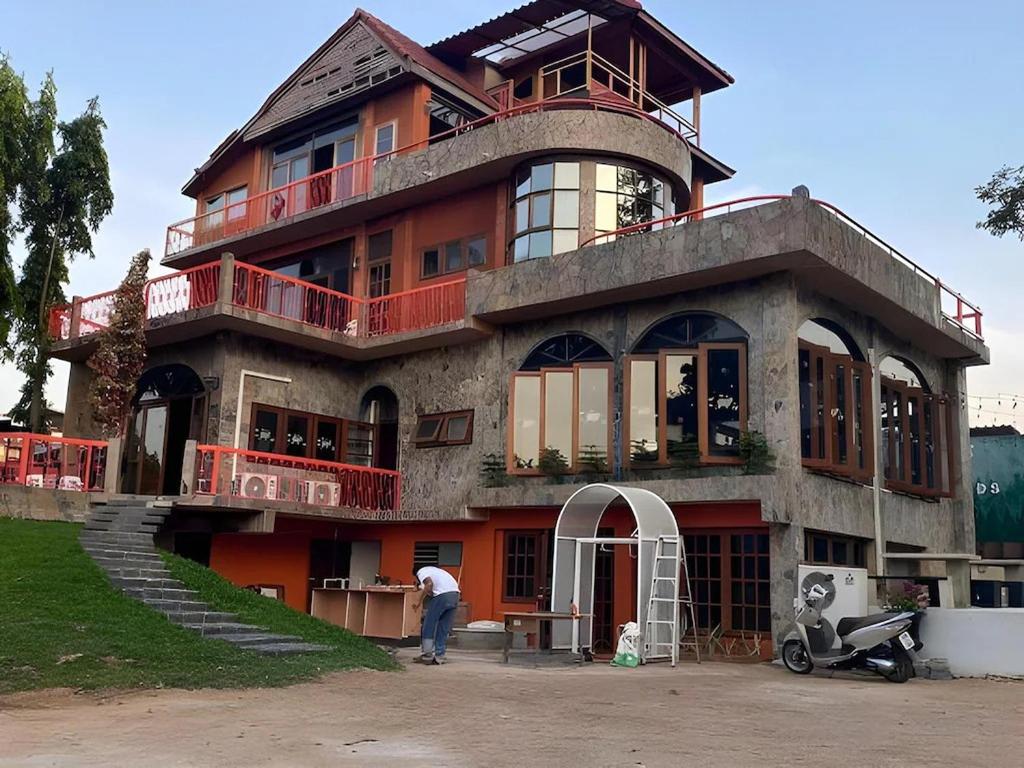 a man standing in front of a house at Nomads Homestay Sriracha in Chon Buri