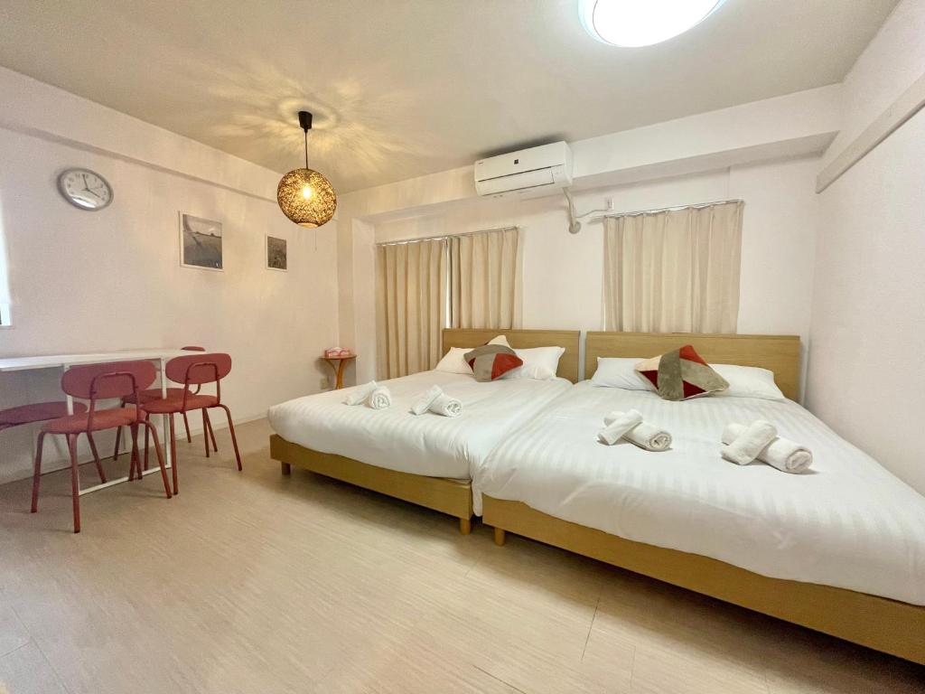 a bedroom with a large bed and a table at YMK Oshiage 5B in Tokyo