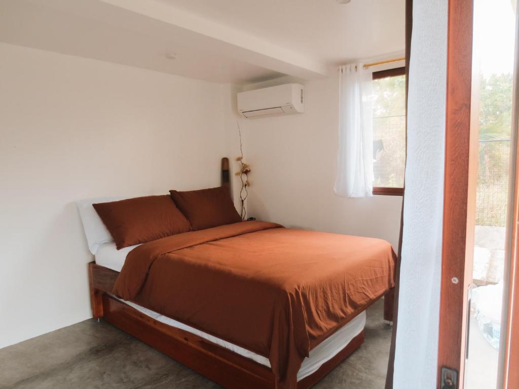 Postel nebo postele na pokoji v ubytování Casa De Amor Lambug