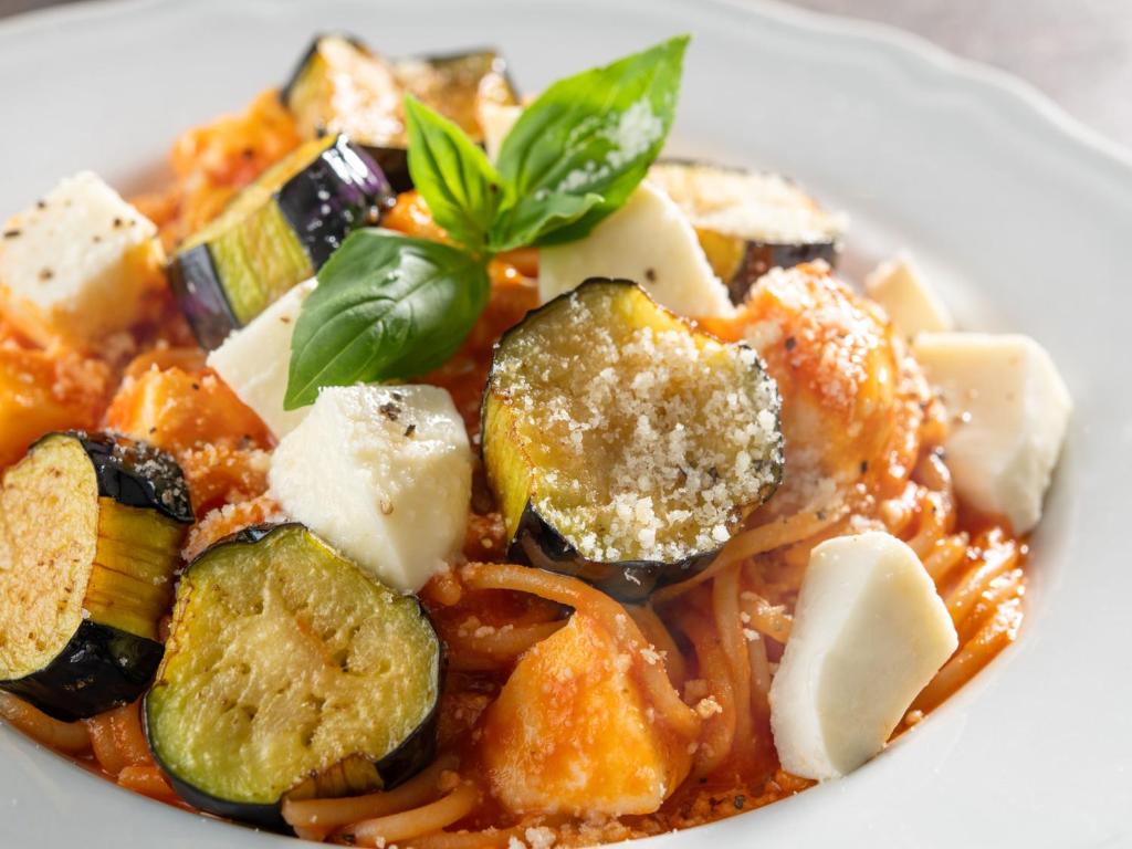 a white plate of food with pasta and vegetables at Hotel Mystays Premier Akasaka in Tokyo
