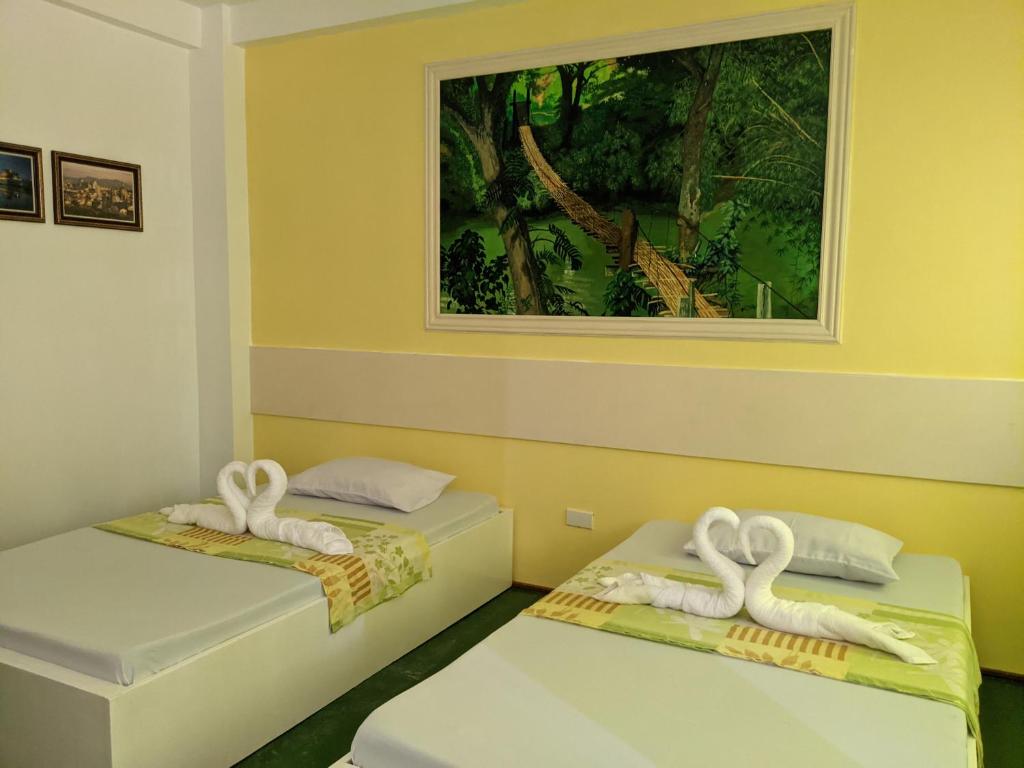 Postel nebo postele na pokoji v ubytování Citadel Alona Inn