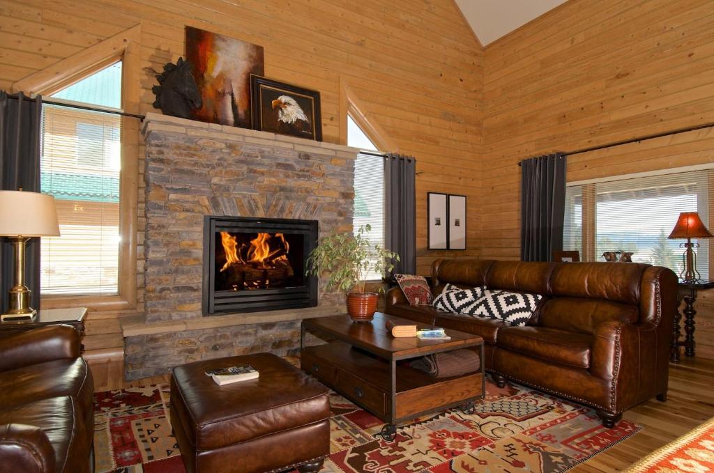 a living room with a couch and a fireplace at Eagles Perch in Rea