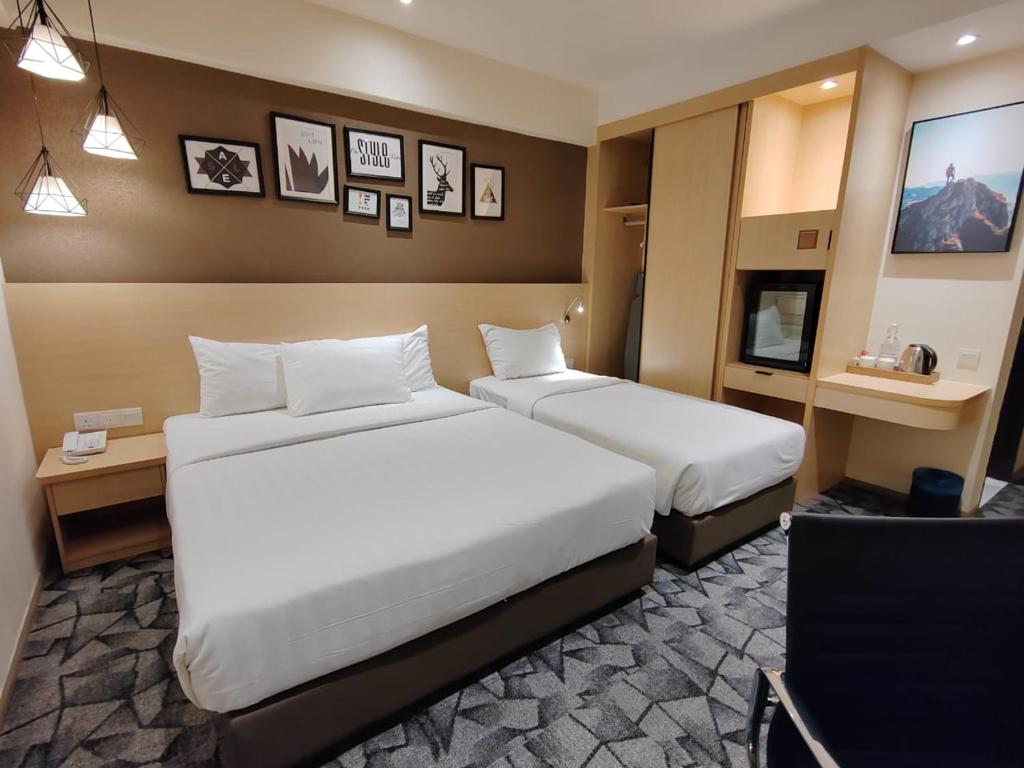 Postel nebo postele na pokoji v ubytování Hotel Damai Kuala Lumpur