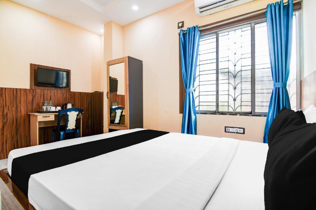 Postel nebo postele na pokoji v ubytování Super Hotel O DumDum Thana More formerly Bimla Regency
