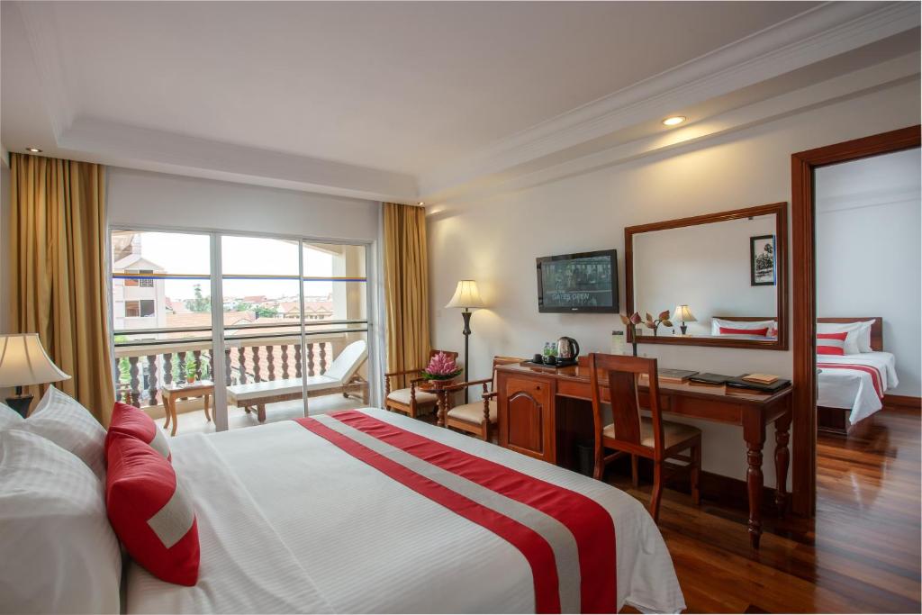 Postel nebo postele na pokoji v ubytování Hotel Somadevi Angkor Resort & Spa